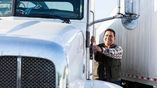 Driver climbing into the cab of his semi-truck